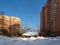 The old rickety wooden house in front of the new residential homes. Balashikha, Russia.