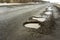 Old road potholes holes outside city autumn weather HDR