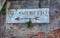 Old road sign with plants on a wall in Venice. Written in Italian Al Vaporetto