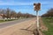 Old road sign on the side of the road. Cracked illegible inscription on a vintage village signpost in a poor quarter. Cracked