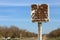 Old road sign on the side of the road. Cracked illegible inscription on a vintage village signpost in a poor quarter. Cracked