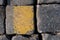 Old road tiles with yellow paint. Street, road details. Vertical background