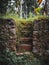 Old rock-walled structure with stairs in the middle in a park in Kerela, India