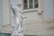 Old roof statue of a Renaissance Era philosopher and poet with bag of food and fruits in Potsdam, Germany, details, closeup