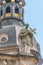 Old roof statute of priest or monk holding a big cross at Dome base of the Cathedral of Holy Trinity, historical center of Dresden