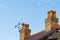 Old rooftop, chimneys, ariel and blue sky copy space.