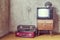 Old room. retro tv and two suitcases