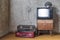 Old room. retro tv and two suitcases