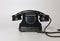 old rotary black telephone with traces of time. back side view. on white background
