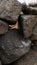 Old, rough dry stone wall with gaps between rocks. Vertical aspect ratio.