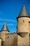 Old rounded medieval towers rising up in blue sky