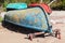 Old rowboats lay on sandy coast. Gulf of Finland