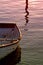 Old Rowing Boat with Oars on Sea During Sunset