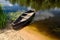 Old rowing boat tied with chain and padlock at green summer bank