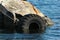 Old rubber tire as fender on a stone pier