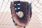Old rugged baseball glove in dugout