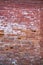 Old ruined brick wall texture, potholes and cement clay