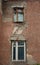 The old ruined building with dirty broken Windows on the figured facade is a historical monument