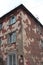 old ruined building with dirty broken Windows on the figured facade is a historical monument