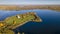 Old ruined church with grass on the roof and bell tower on island. Aerial view of old church ruins