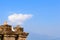 Old ruined Grit stone stone wall background against blue sky with cotton wool clouds and Kanchenjunga mountain range. Rabdentse