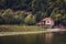 Old ruined house on shore in Montenegro. Green nature background