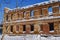 Old ruined red brick building against a blue winter sky