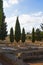 Old ruined roman square and cypress trees. Light sunny day, Seville, Spain