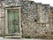 Old ruined stone made wall with green door and window frame in Zminj in Istria,Croatia