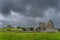 Old ruins of Hore Abbey and Rock of Cashel castle with dark dramatic storm sky in the background