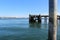 An old run down pier in a bay and a view of an old town