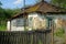 Old rural house with frayed walls wooden windows