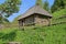 An old rural house on a green hill.