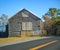 Old Rural Remote Aged Vintage Wooden Warehouse Building along the Street. Barn, Farmhouse, Garage, Storage, Granary, Logistics,