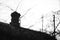 Old rural roof with brick chimney and antennas. BWhoto