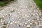 old rural stone paving urban square made of quartz boulders the size of about 15cm joints filled with gravel brown beige white