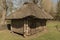 An old rural thatched-roofed farmhouse built of logs