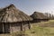 An old rural thatched-roofed farmhouse built of logs