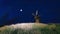 Old rural windmill under night sky with full moon