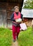 Old rural woman with pumpkin outdoor