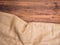 Old rural wooden table boards and burlap vintage background, photo top view. Hessian, sacking texture on wooden