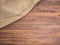 Old rural wooden table boards and burlap vintage background, photo top view. Hessian, sacking texture on wooden