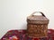 Old Russian folk style. A basket of birch bark stands on a Pavlovoposad red scarf on a white background