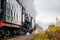 Old Russian locomotive on the railway. Old black locomotive. Smoke from the engine. Russian railway. Russia, Leningrad region