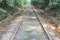 Old rust railroad trucks for cargo railway trains in green gorge with trees in summer in daylight