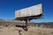 Old rusted blank billboard by road