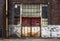 Old Rusted Metal Doors on Abandoned Decaying Brick Factory Building