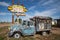 Old rusted neon sign and busted up classic truck at the abandoned Ranch House Cafe along