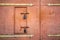 Old rusted padlock hanging on gray metal retro door