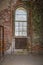 Old rusted radiator under a paladian window